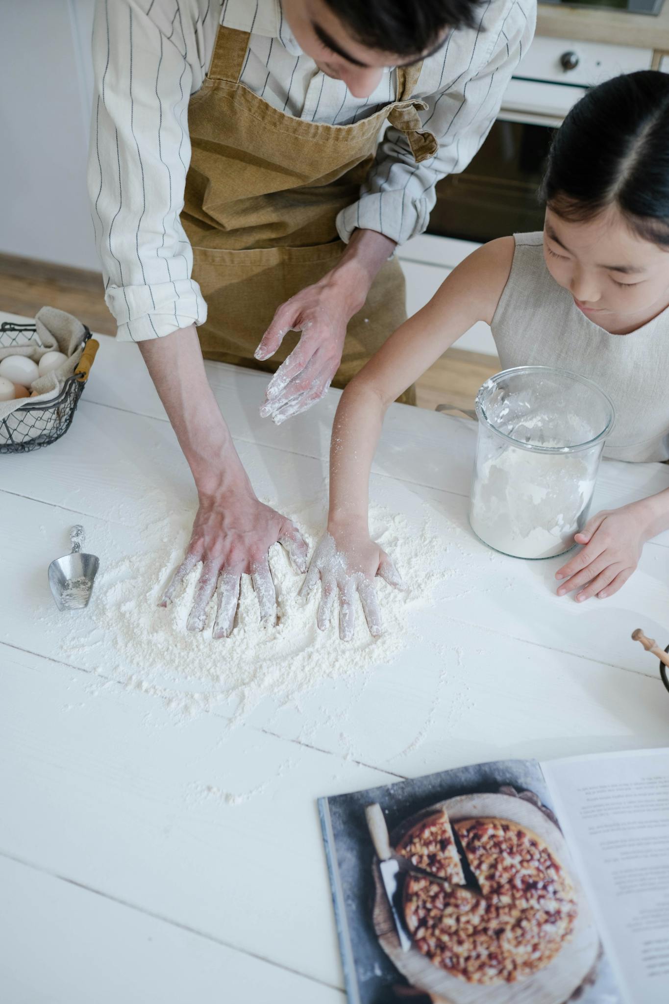 A father and daughter enjoy quality time baking together at home.