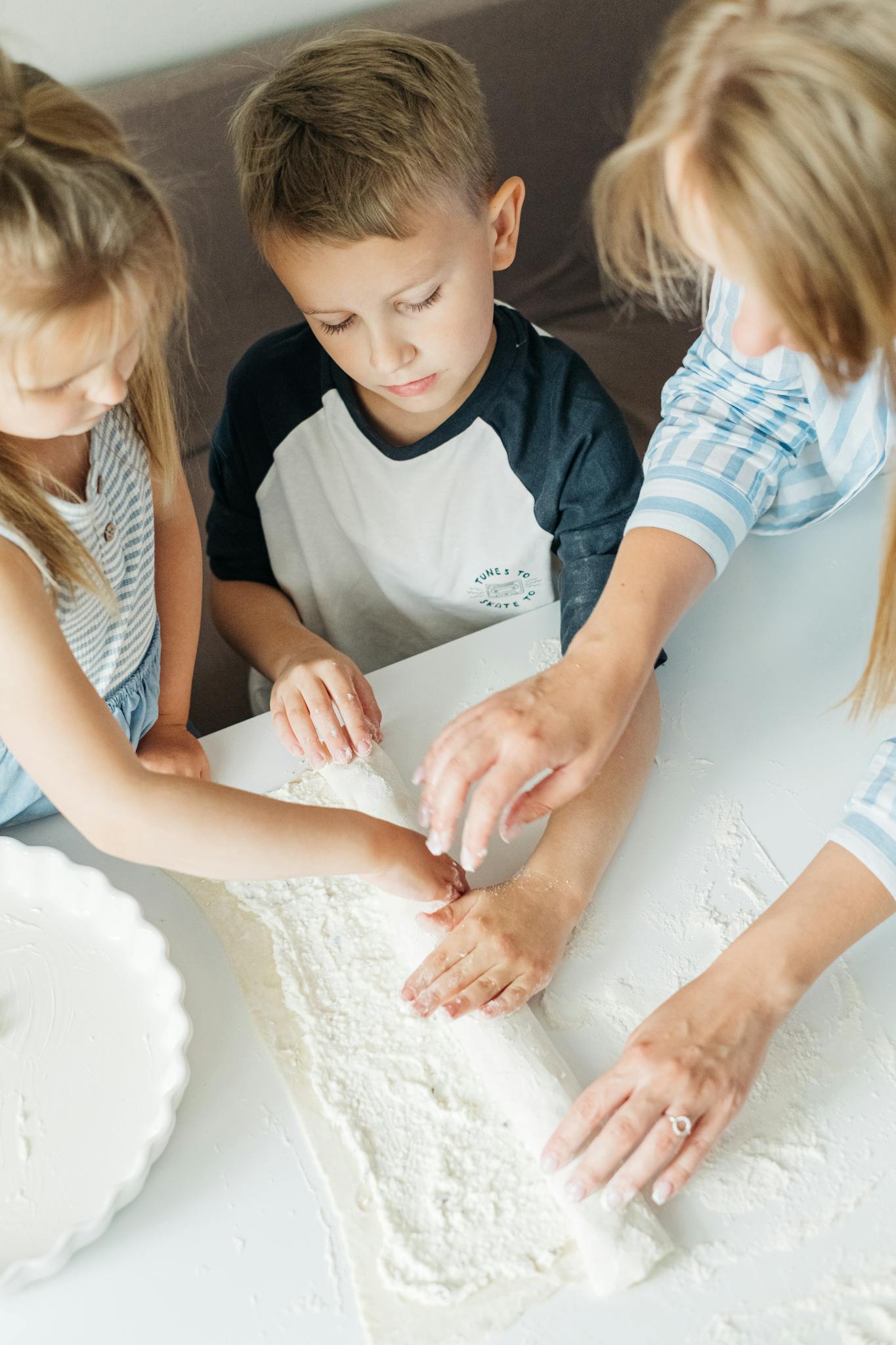 A joyful family bonding while baking together, sharing fun and love in the kitchen.