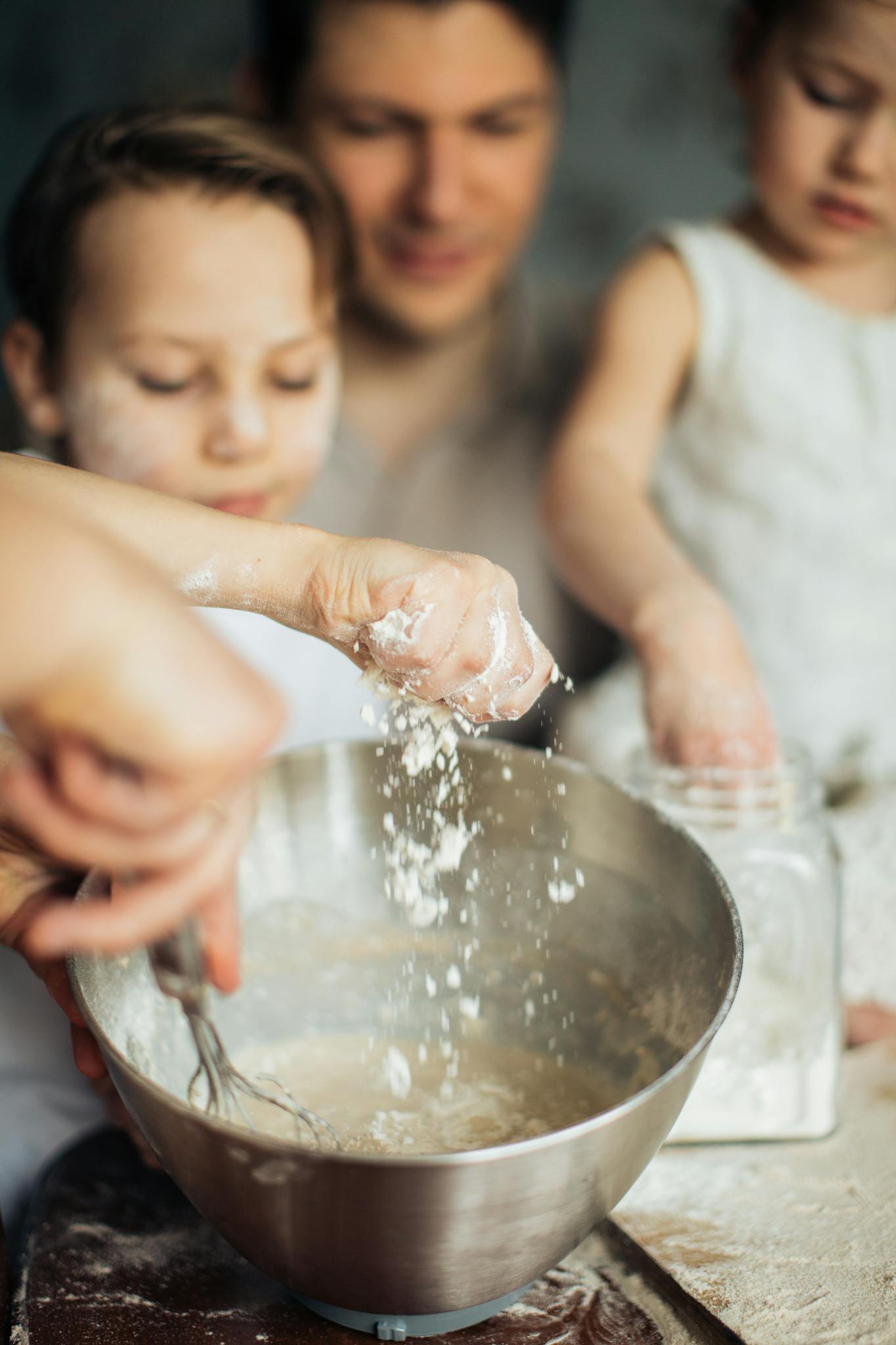 Family preparing dough in the kitchen, enjoying a fun baking session together.