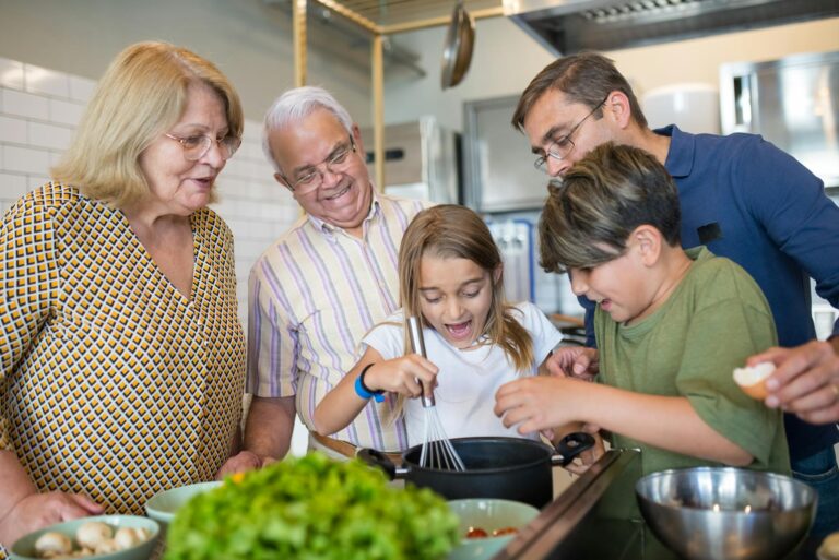 Happy family of five bonding and cooking together in a home kitchen.